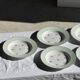 Set of 9 vintage turquoise deep plates with gold trim and pink flowers.