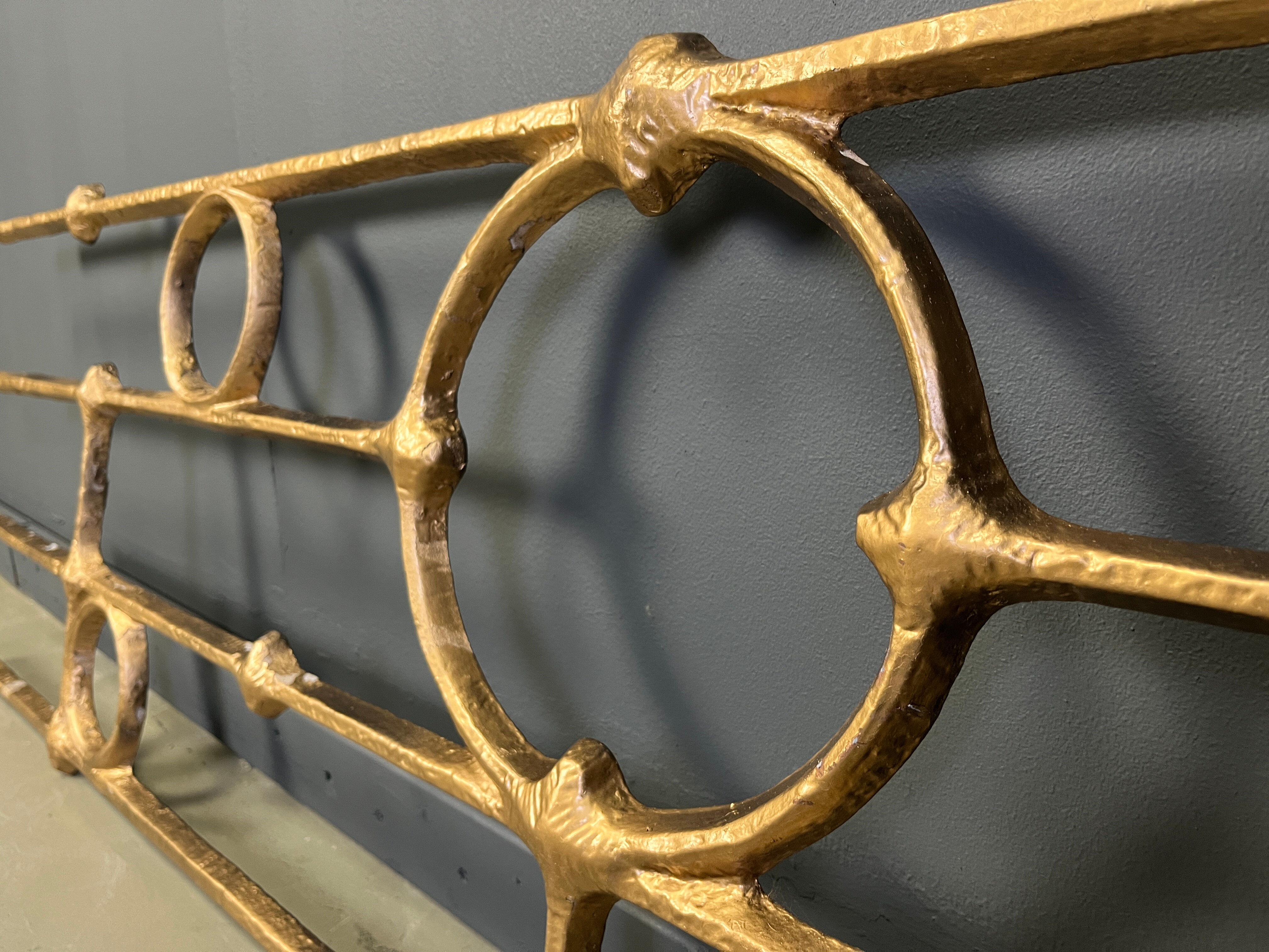 Architectural brutalist wall mounted sculpture made from cast metal.