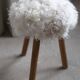 Danish mid-century tripod stool in beech, reupholstered in lambswool, 1960s.