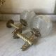 Pair of neoclassical wall sconces in twisted brass and ribbed glass.
