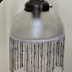 Retro brass lamp with a glass shade and bead fringes.