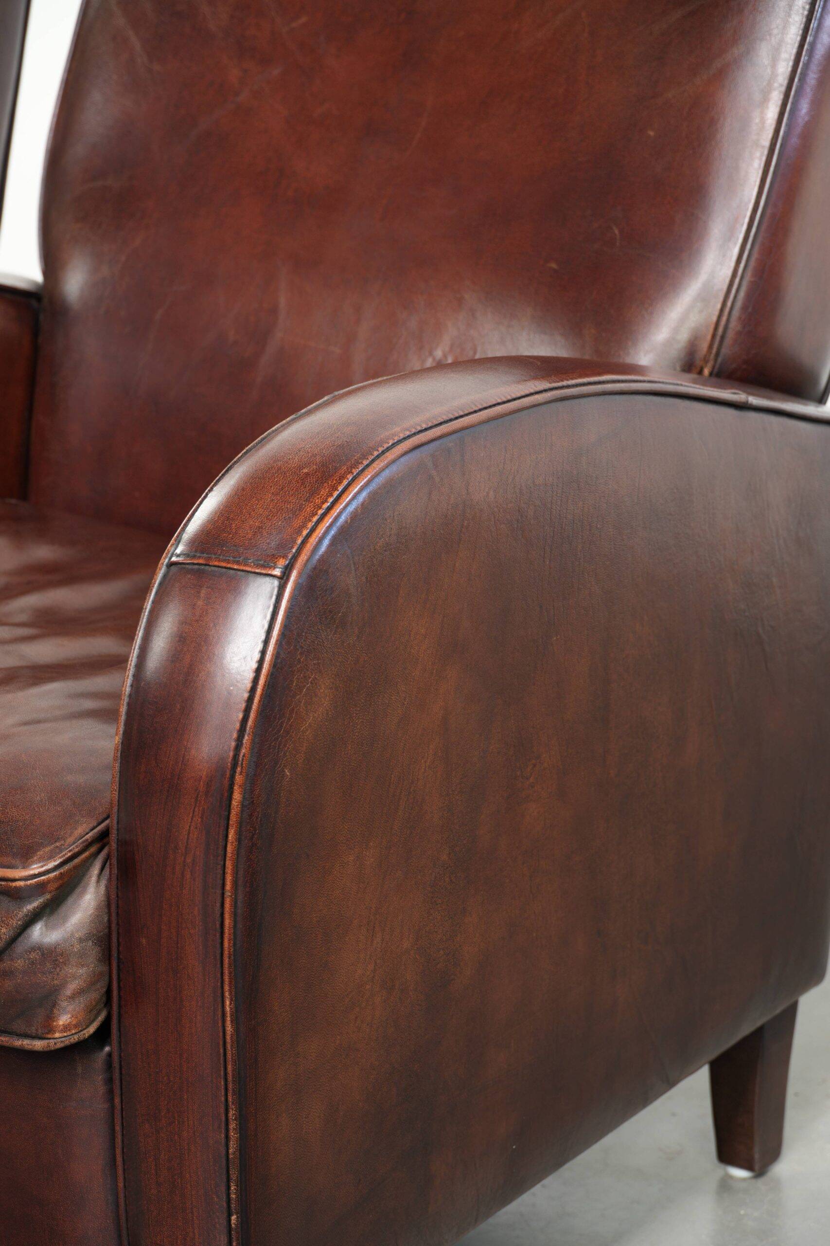 Dark cognac-coloured set of 2 sheepskin armchairs with a sleek design