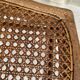 Low wooden stool with caning, footrest.