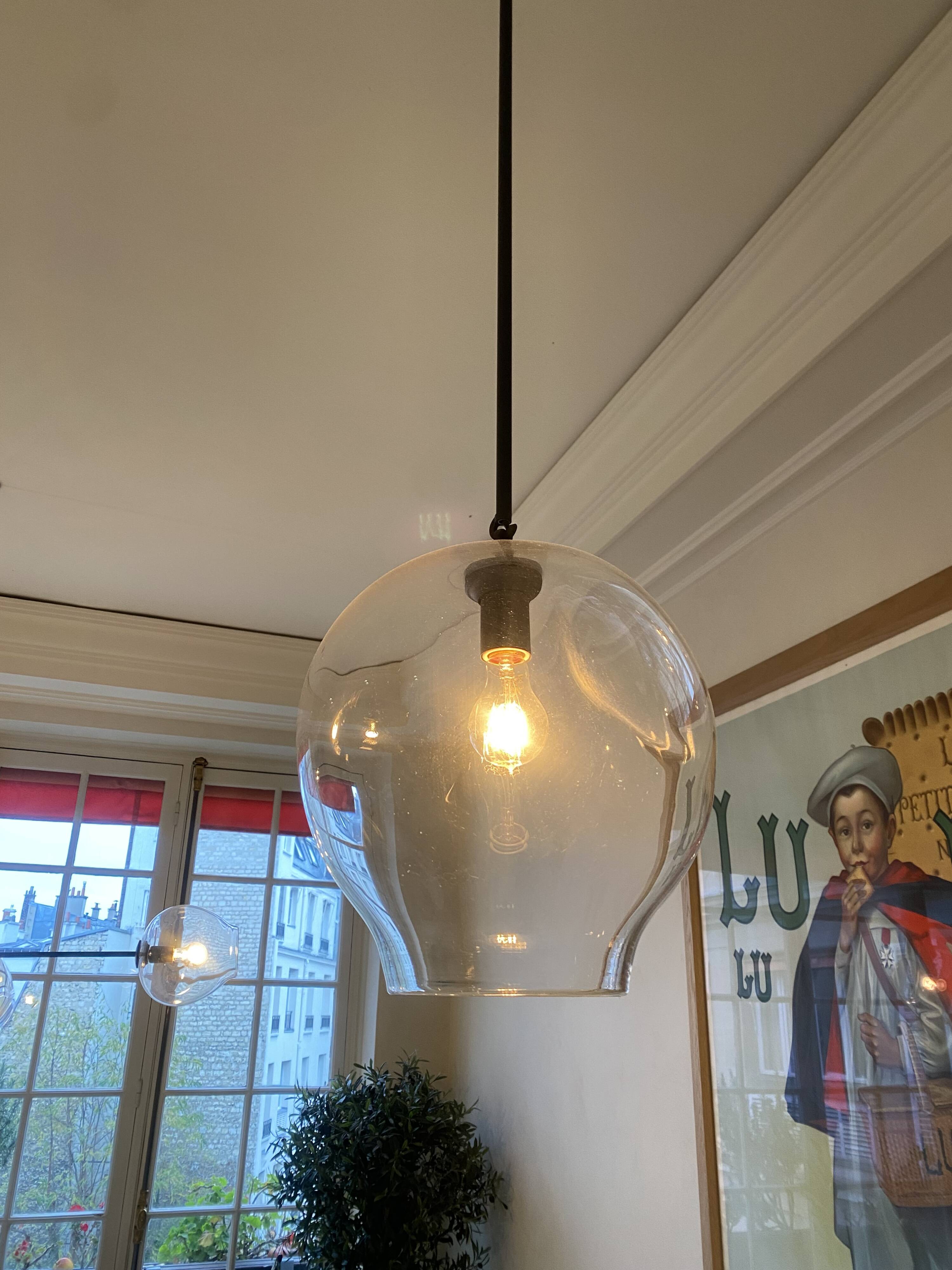 Suspension design by Lindsey Adelman studio in oil-rubbed bronze and clear glass.