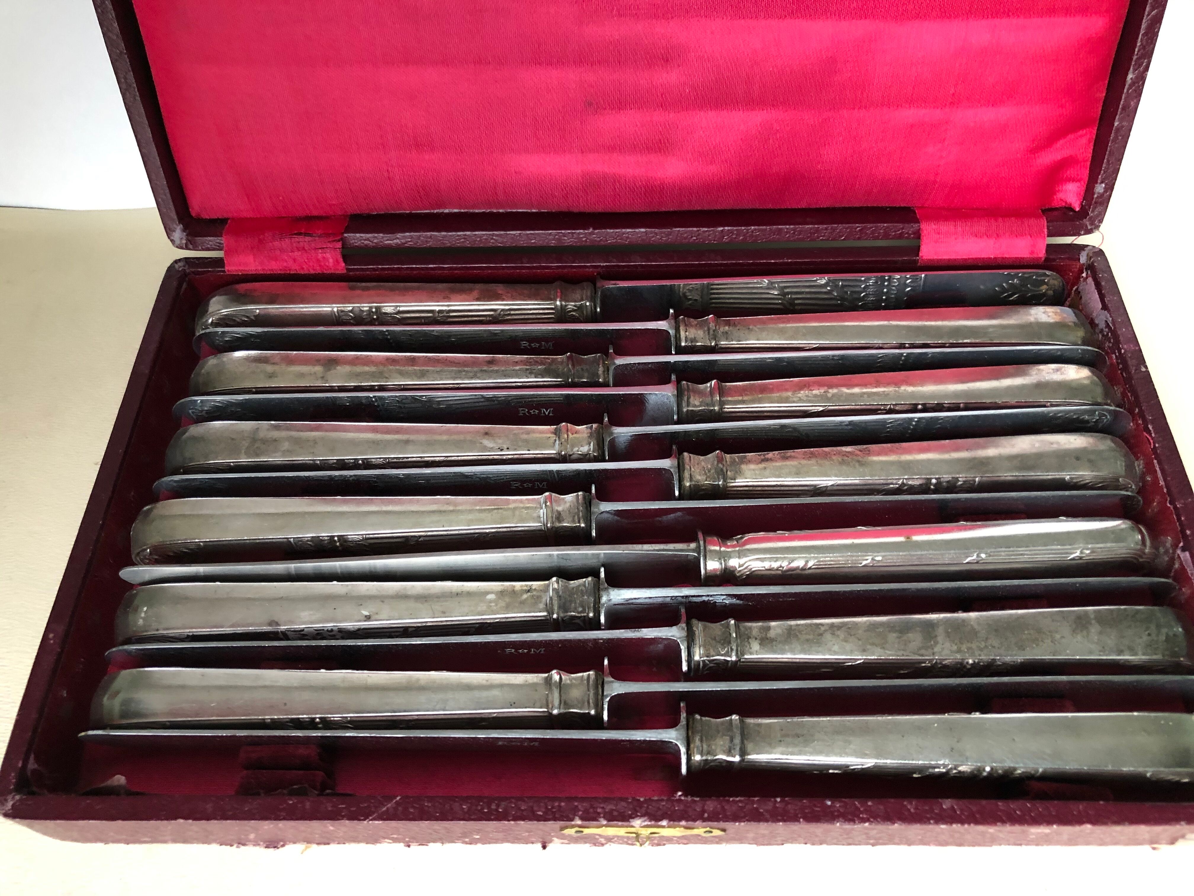 Set of 12 silver metal knives