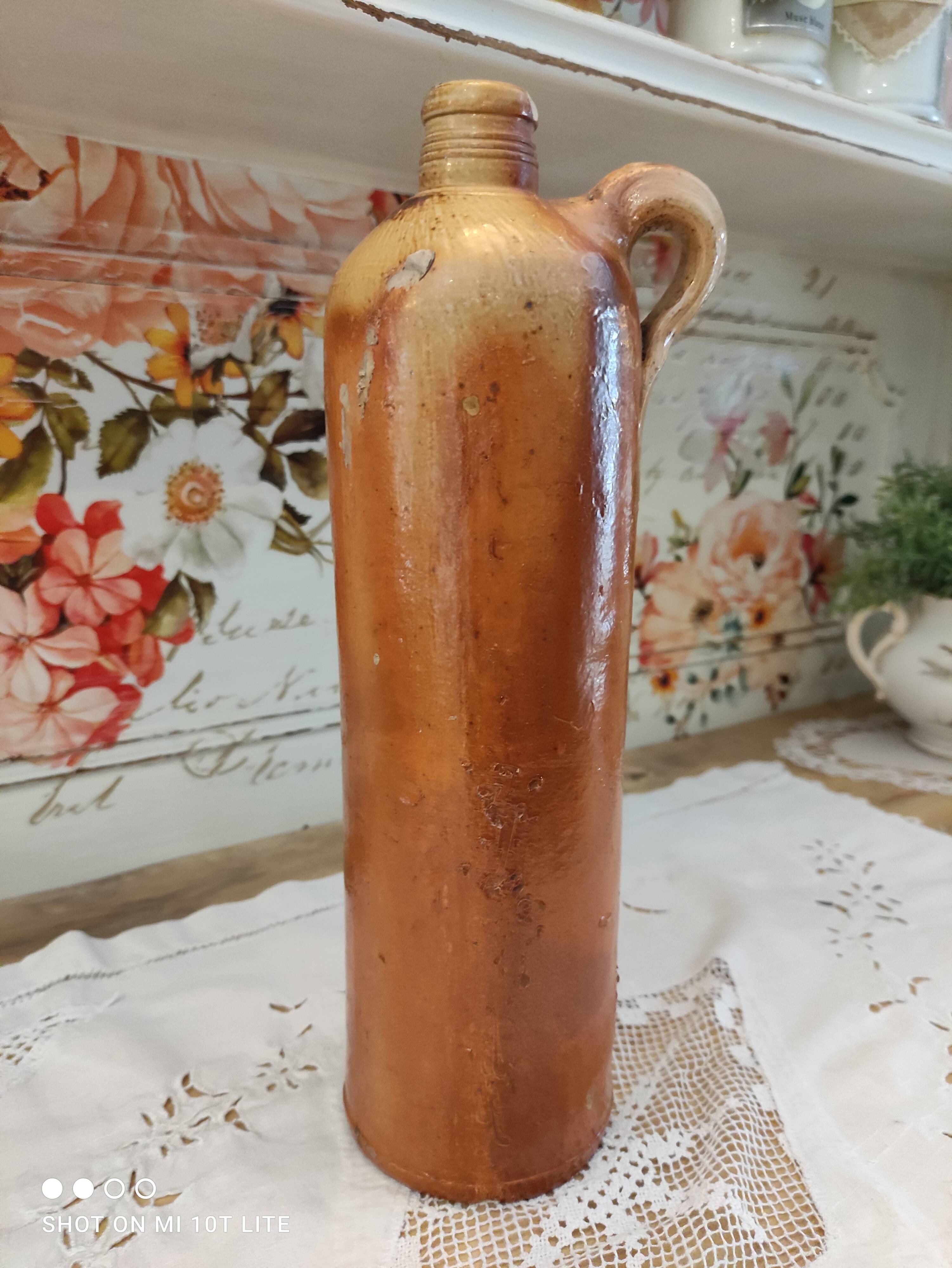 Old bottle in terracotta varnished finish