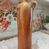 Old bottle in terracotta varnished finish