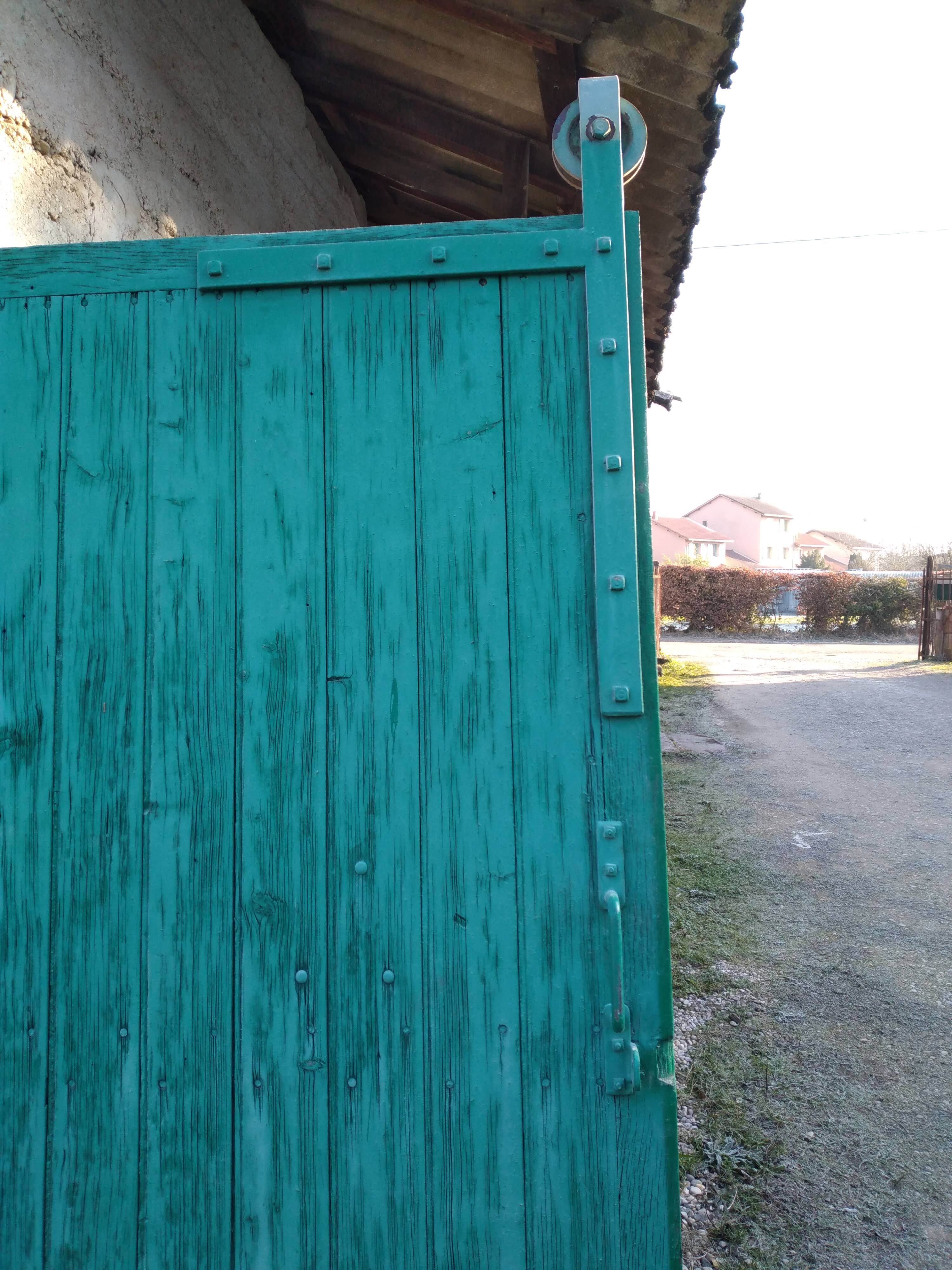 Old wooden door with pulley