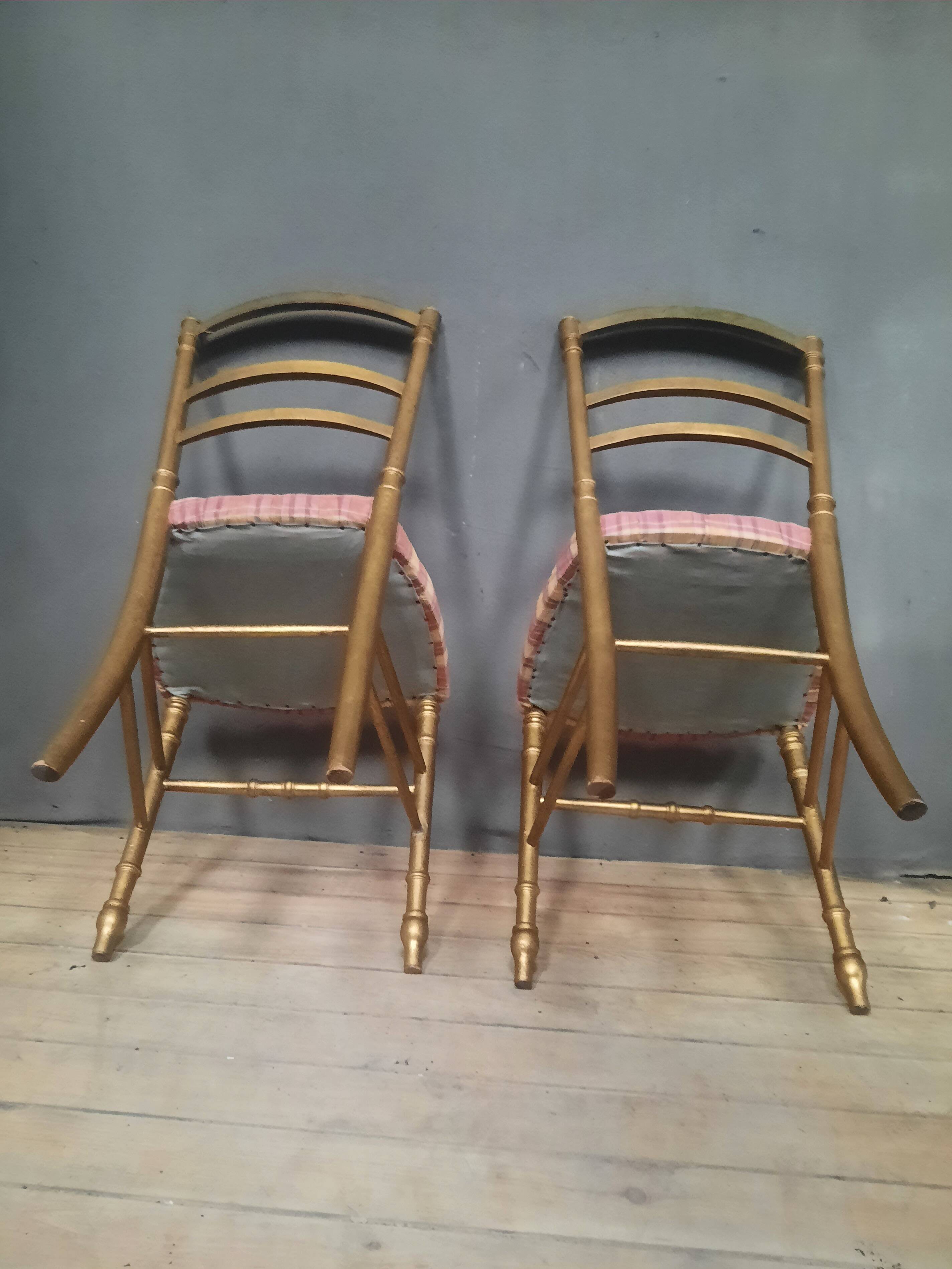 Pair of upholstered chairs in gilded wood