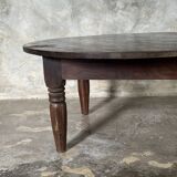 Coffee table, round antique Indonesian teak table with straight legs.