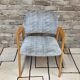 Vintage armchair from the 60s/70s in wood and grey fabric – with armrests.