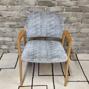 Vintage armchair from the 60s/70s in wood and grey fabric – with armrests.
