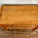 Modernist vintage chest of drawers in light chene has 3 drawers rattan top changing table