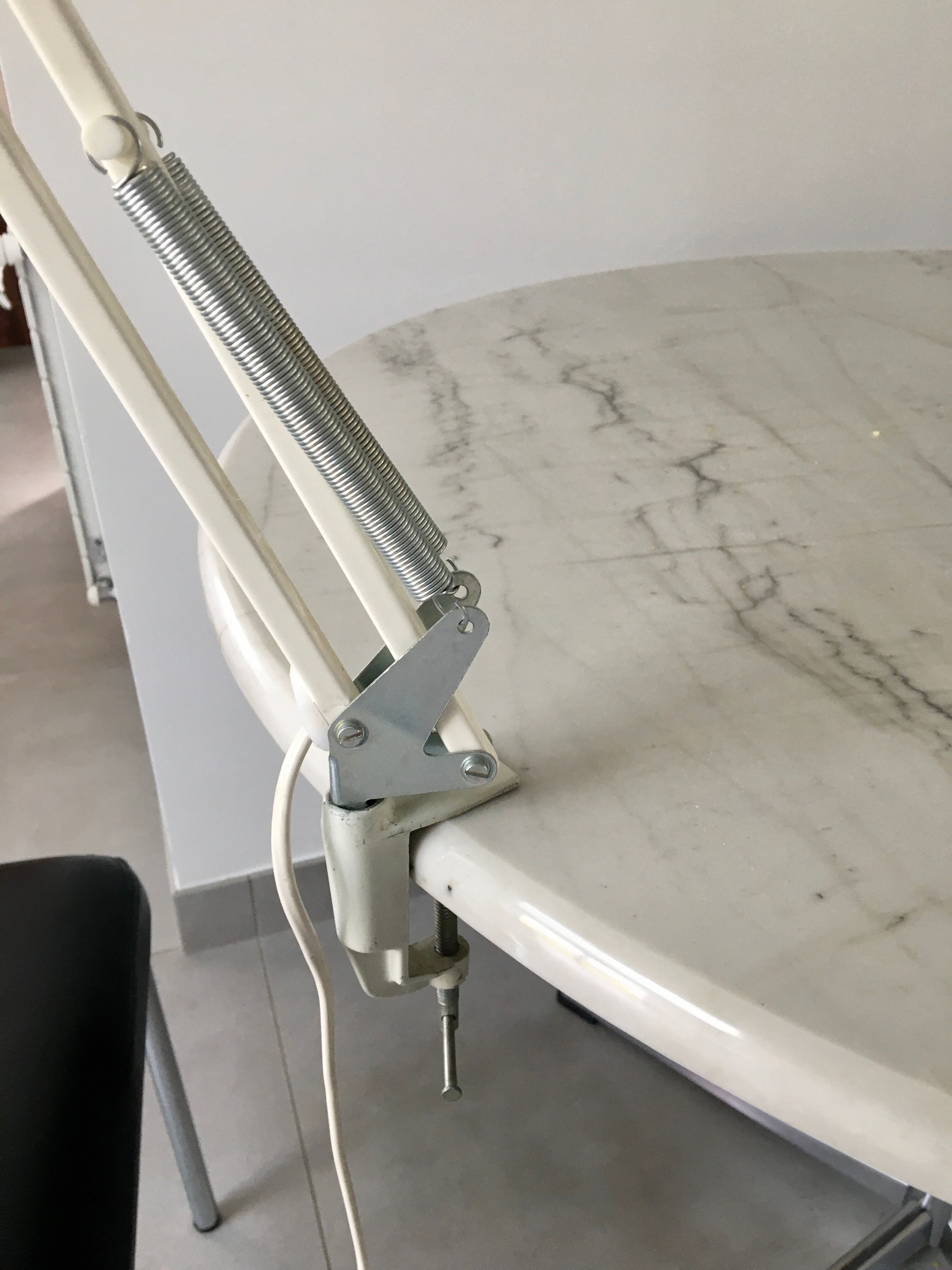 Off-white articulated architect lamp.