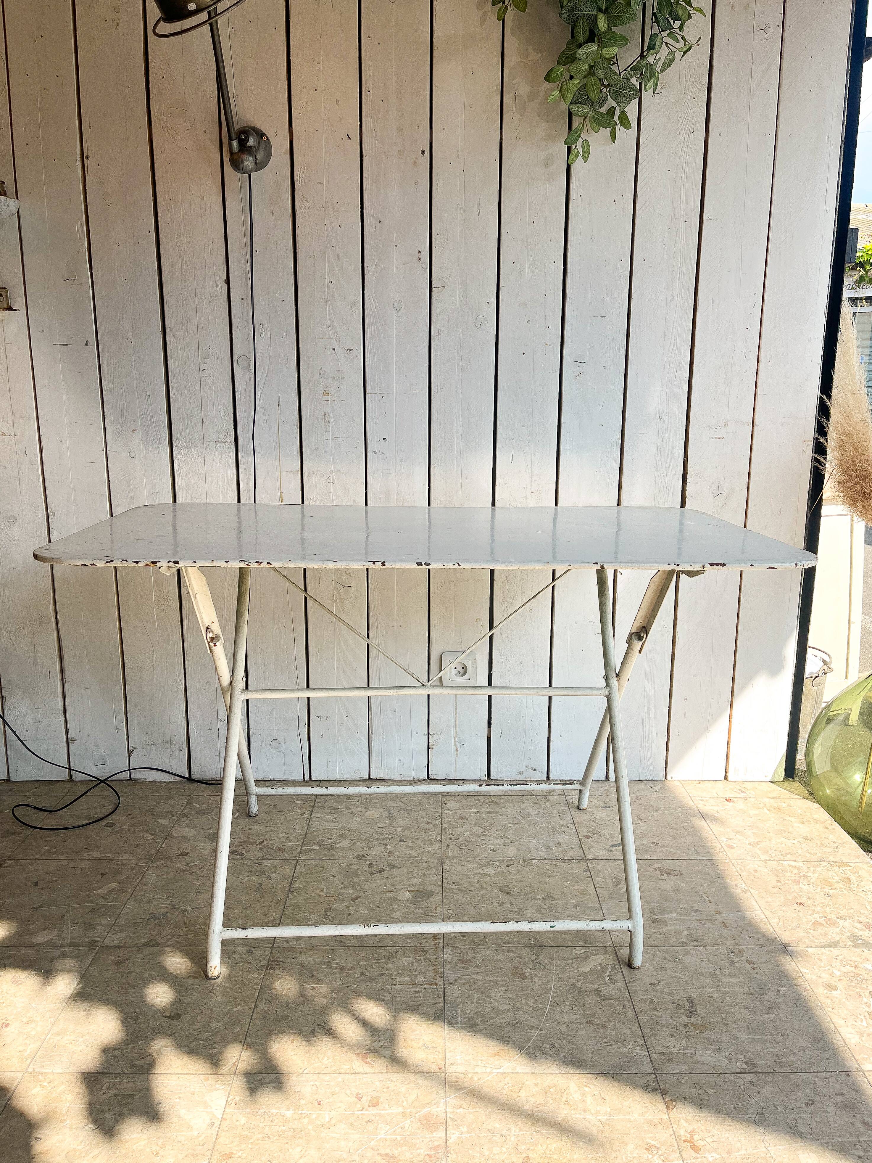 White folding metal bistro table