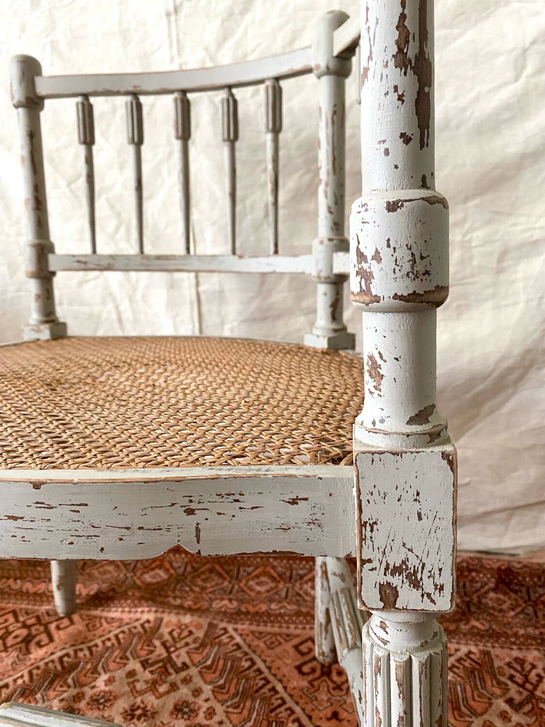 19th-century corner fireplace armchair, wood and cane.
