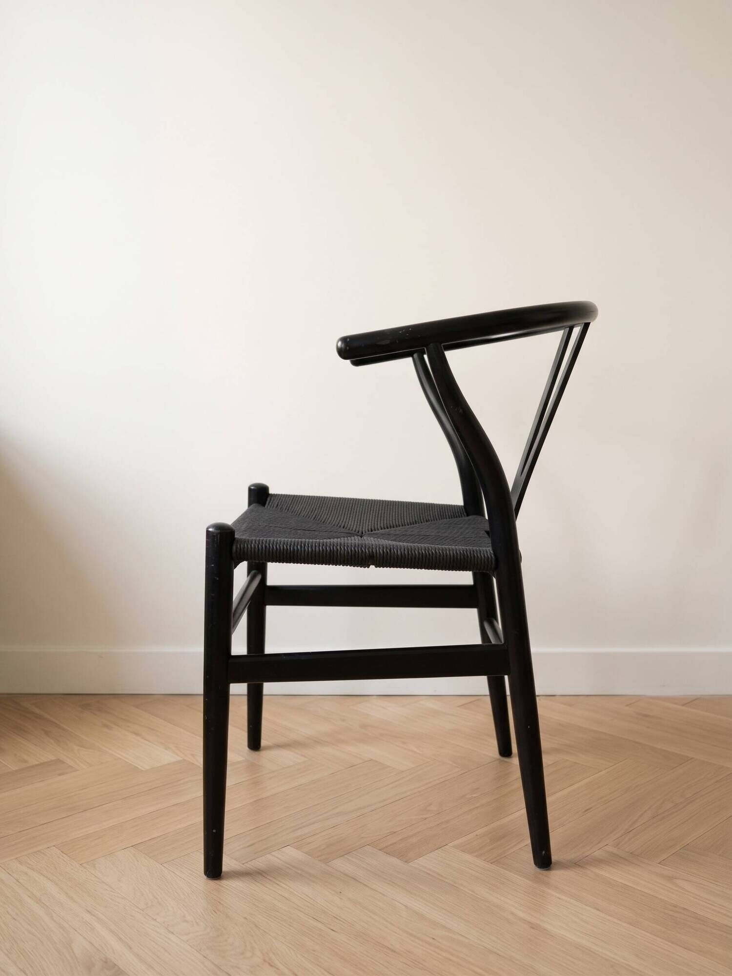 Set of 4 vintage Scandinavian Wishbone style chairs in black wood.