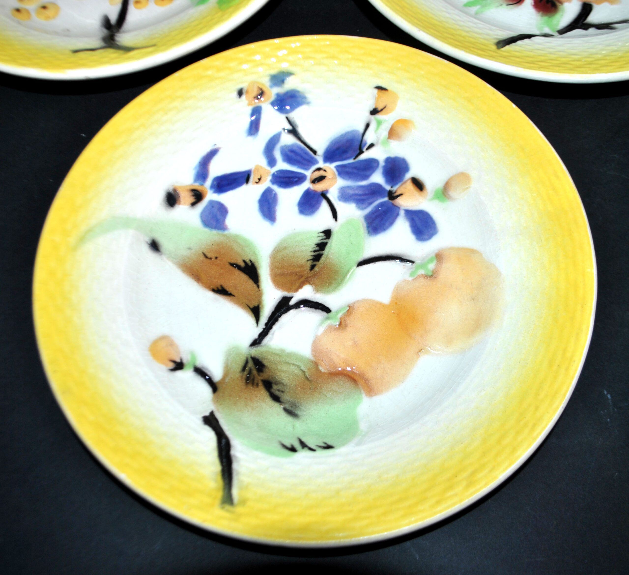 Orchies set of 6 yellow earthenware dessert plates with stencilled fruit decoration.