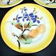 Orchies set of 6 yellow earthenware dessert plates with stencilled fruit decoration.