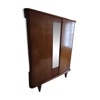 Vintage 1960s wooden wardrobe with a central mirror and tapered legs.