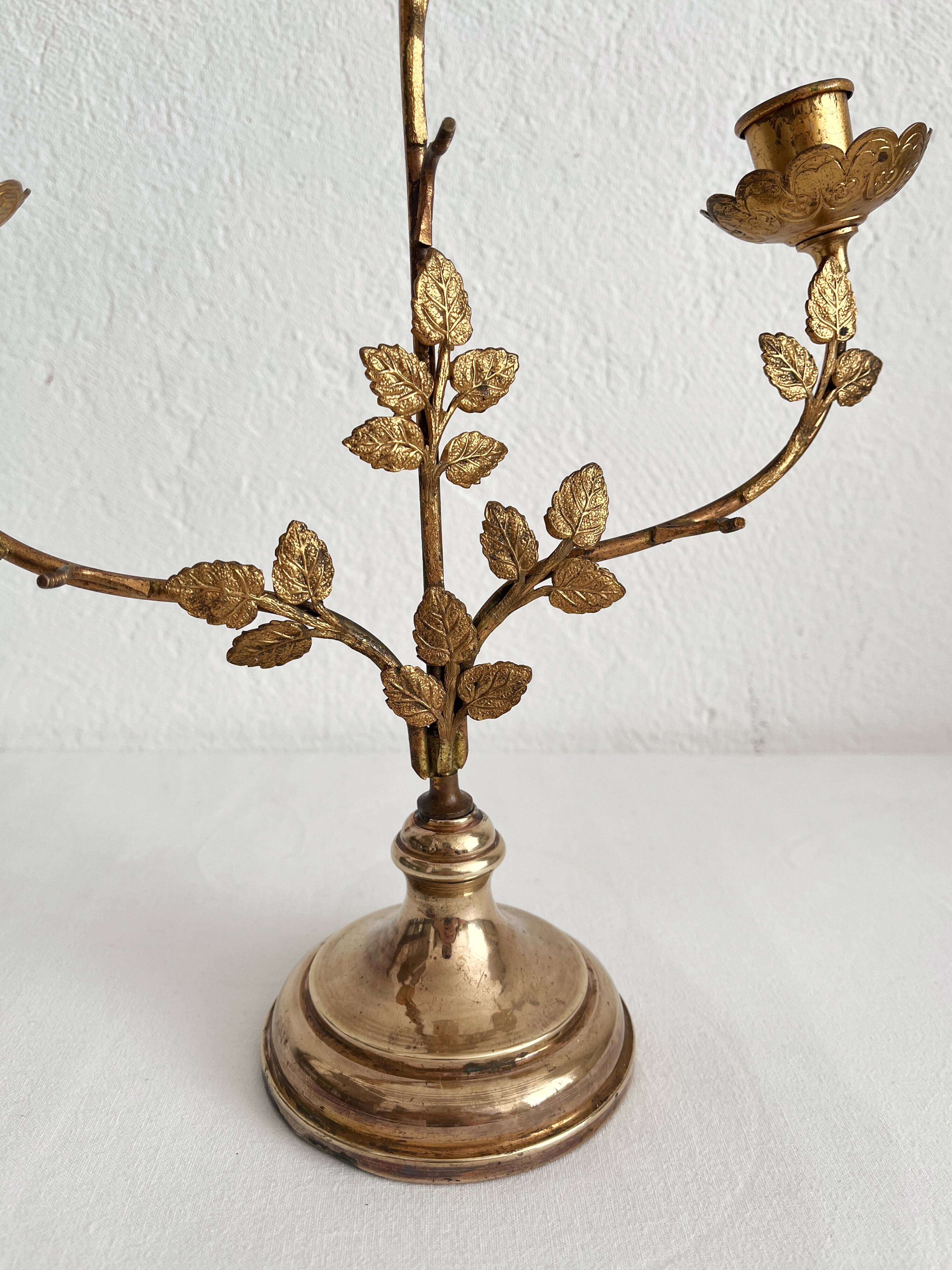 Antique bronze and brass candlestick with golden leaves