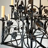 Lustre with 12 lights in wrought iron decorated with clovers and foliage.