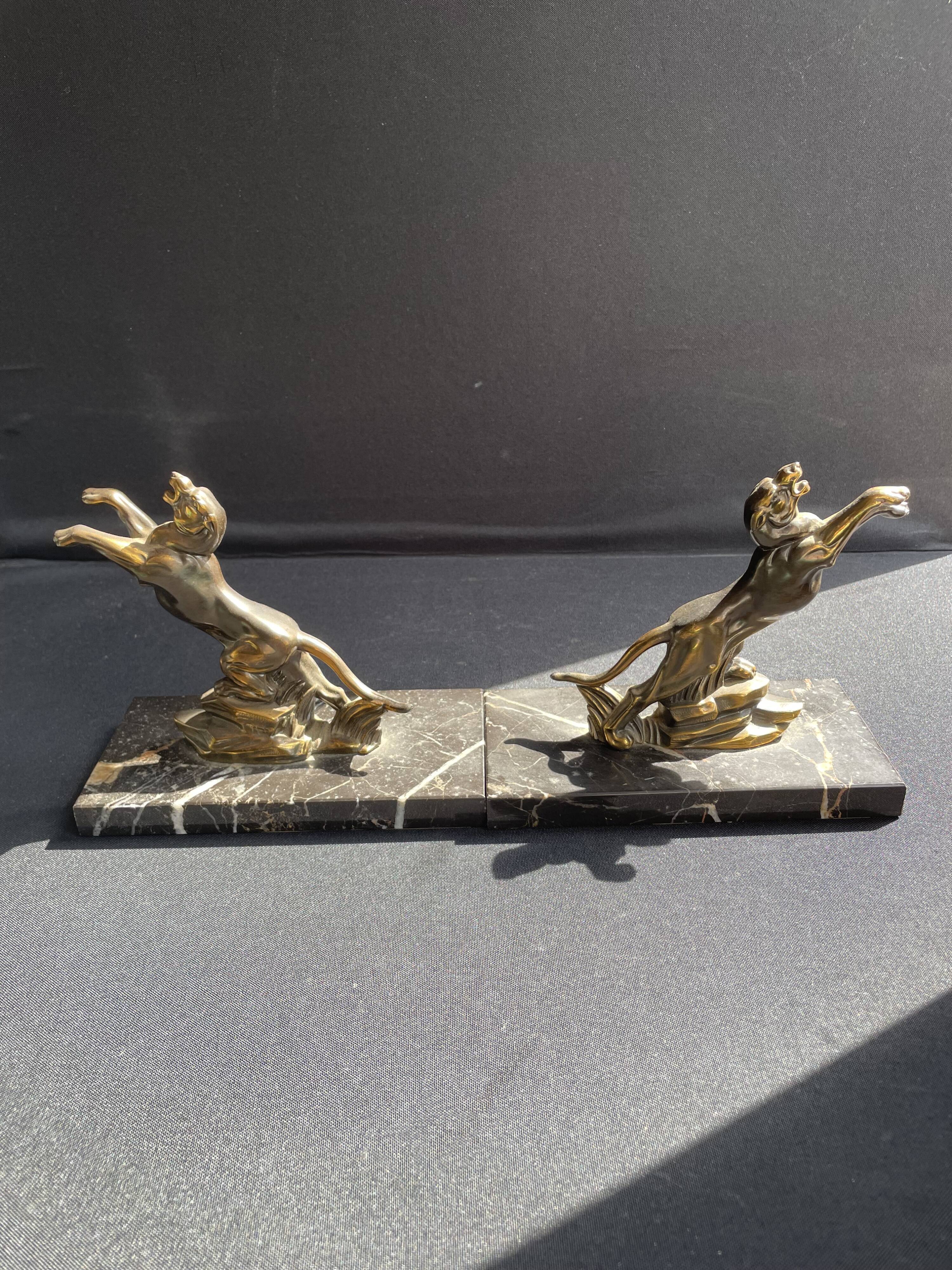 Pair of art deco marble and patinated regulated bookends