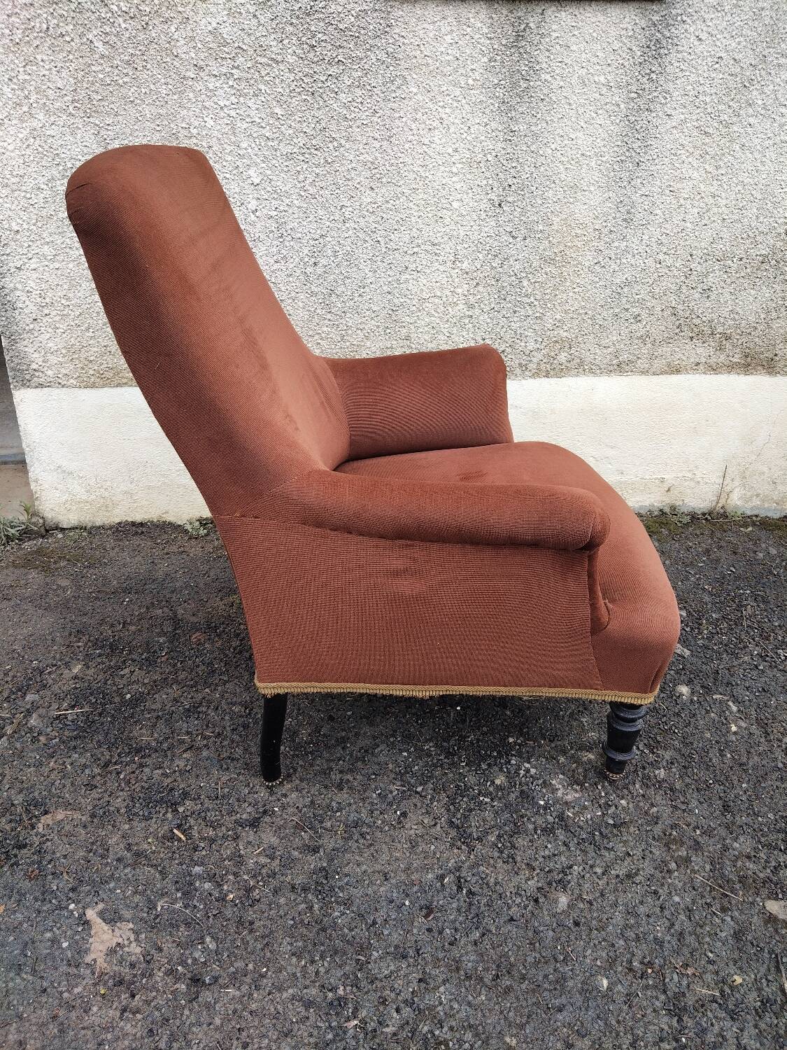 Antique brown velvet tub chair – turned legs and brass rings.