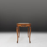 Side table with sculpted elements and rattan top