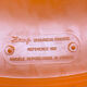 Orange tam-tam by Stamp with integrated pocket.