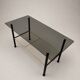 Table basse vintage verre fumé, métal noir et laiton — années 70