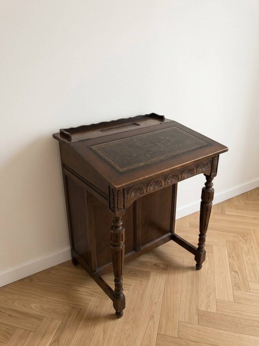 Antique wooden desk with a leather top.