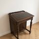 Antique wooden desk with a leather top.