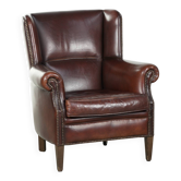 Vintage sheepskin armchair with a high back finished with decorative nails