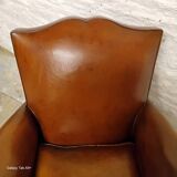 Antique club chair with mustache back