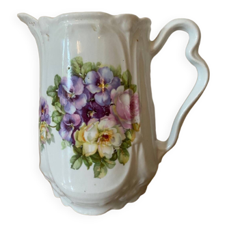Old ceramic pitcher decorated with flowers