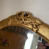 Oval mirror in gilded wood with knot, 32x37 cm