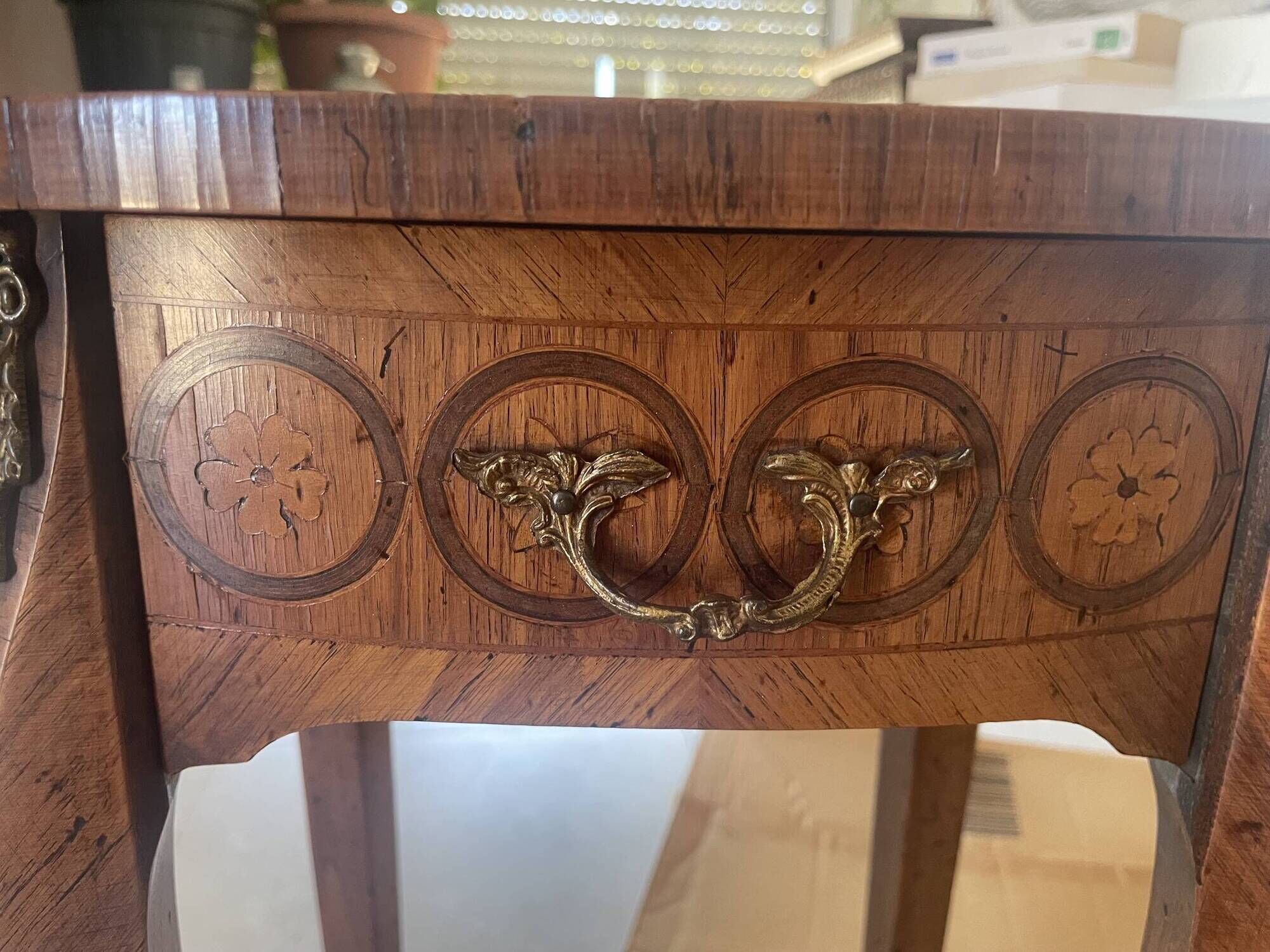 Oval bedside table from the Transition period in marquetry and bronze.
