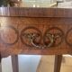 Oval bedside table from the Transition period in marquetry and bronze.