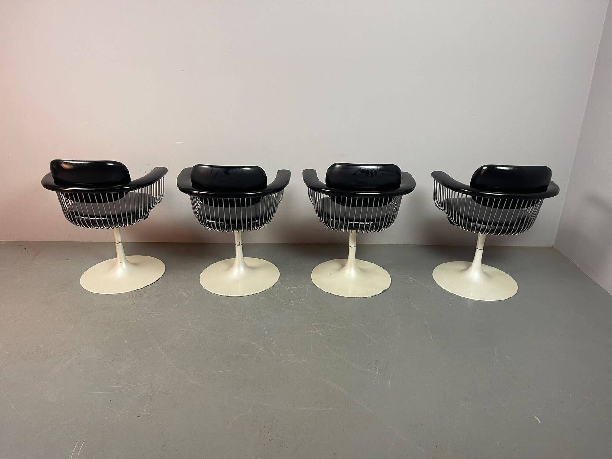 A striking set of four vintage swivel dining chairs