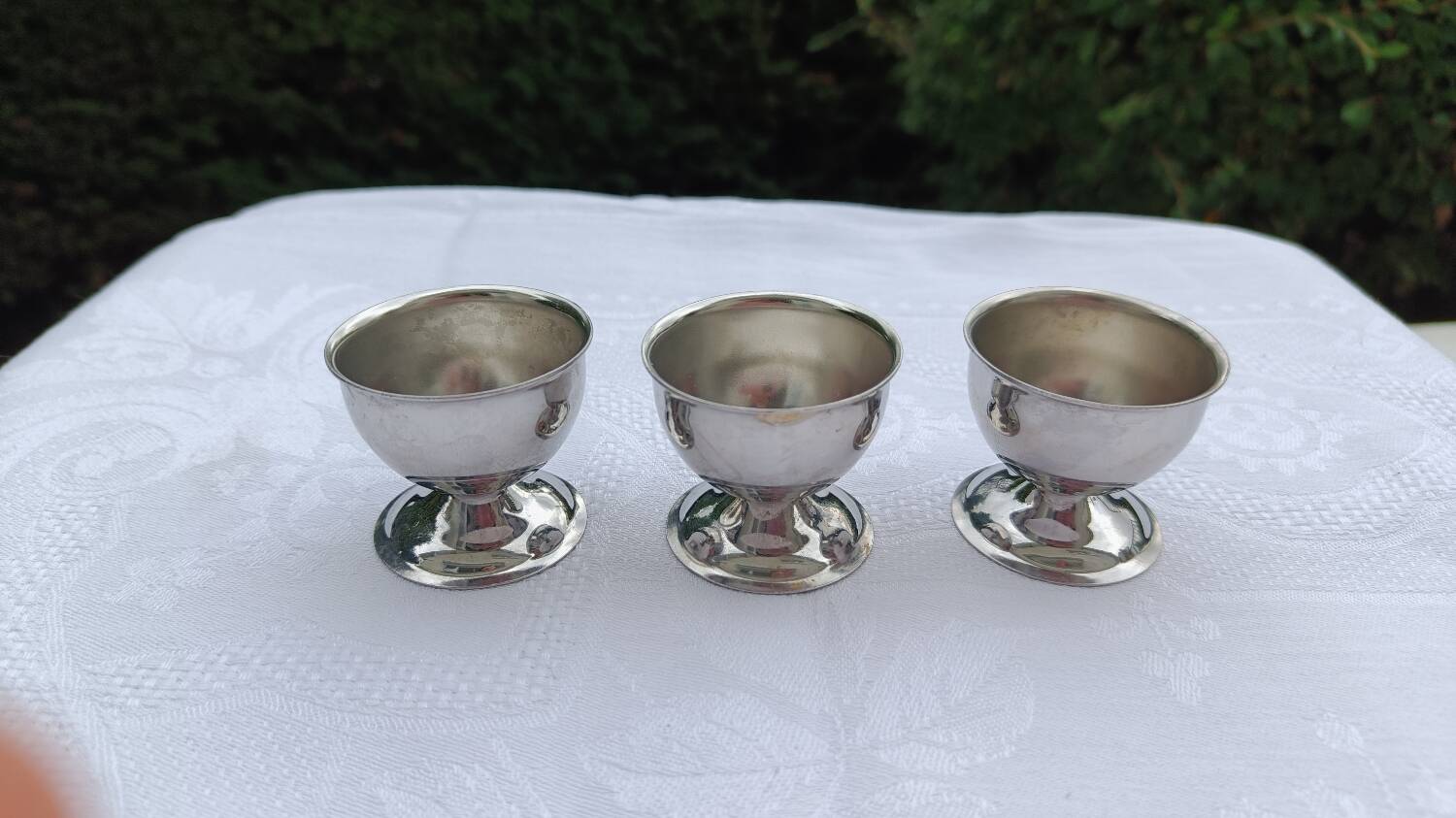 A set of 3 egg cups by Guy Degrenne.