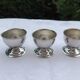 A set of 3 egg cups by Guy Degrenne.