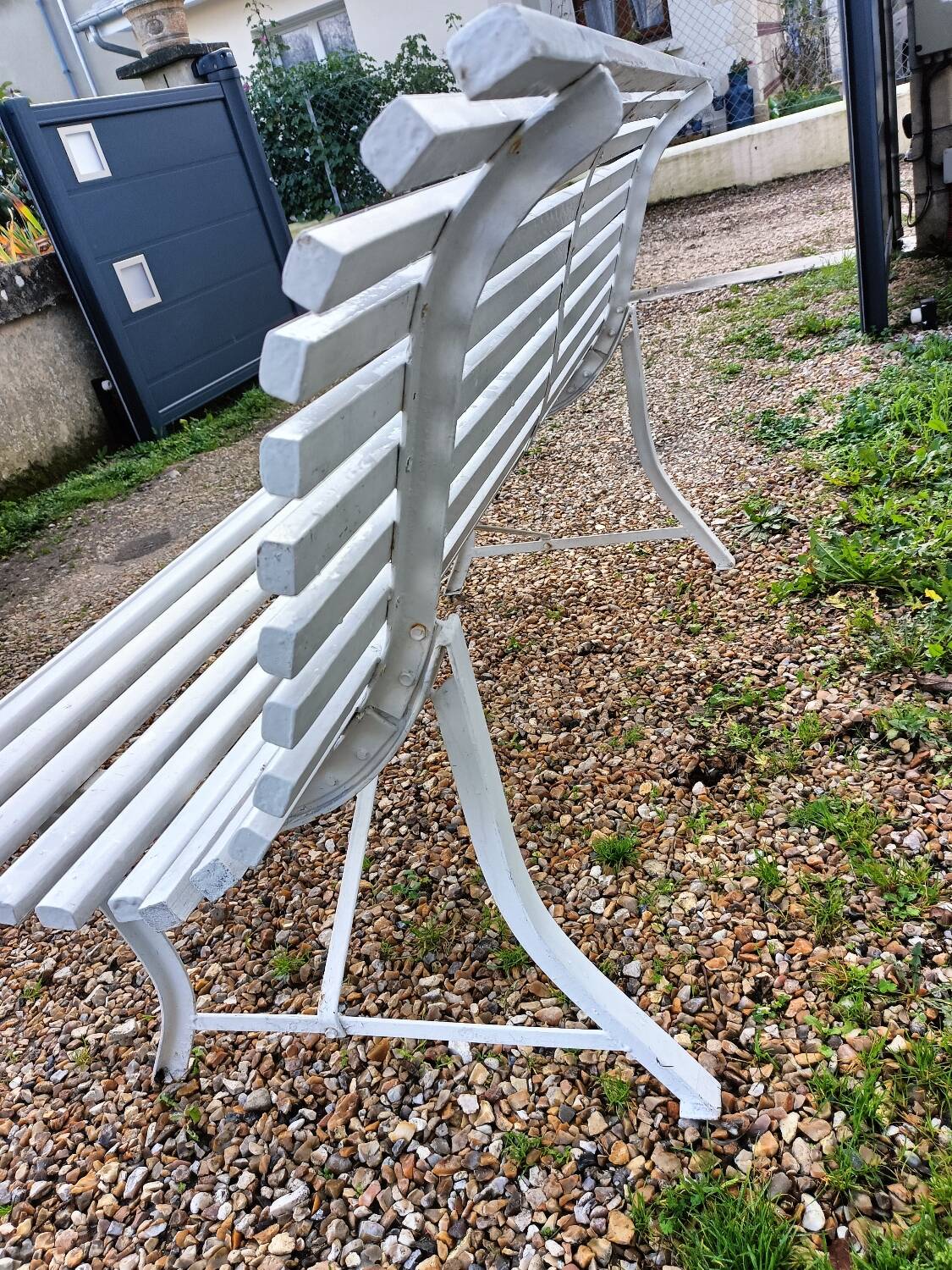Old garden bench with metal legs and wooden slats