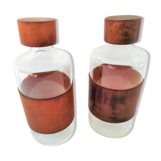 Pair of identical carafes with leather ring and vintage leather cap