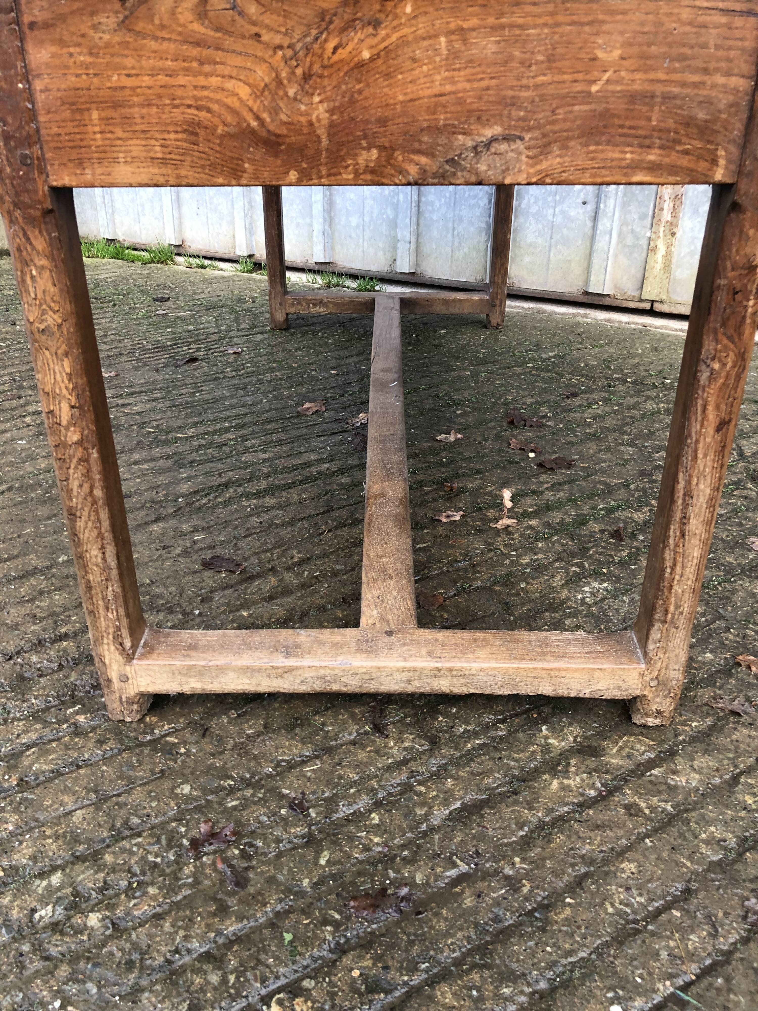 Old chestnut table with 3 front drawers and a cat bar.