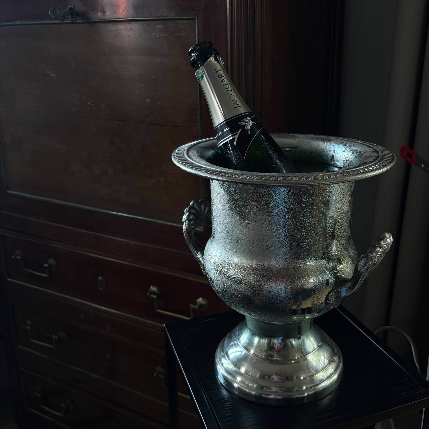 Silver metal champagne bucket.