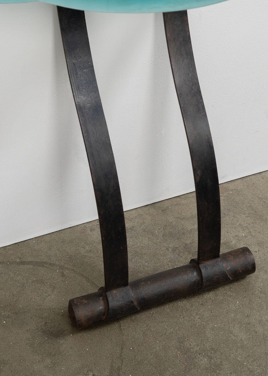 Artisanal wrought iron and cast glass leaning console table