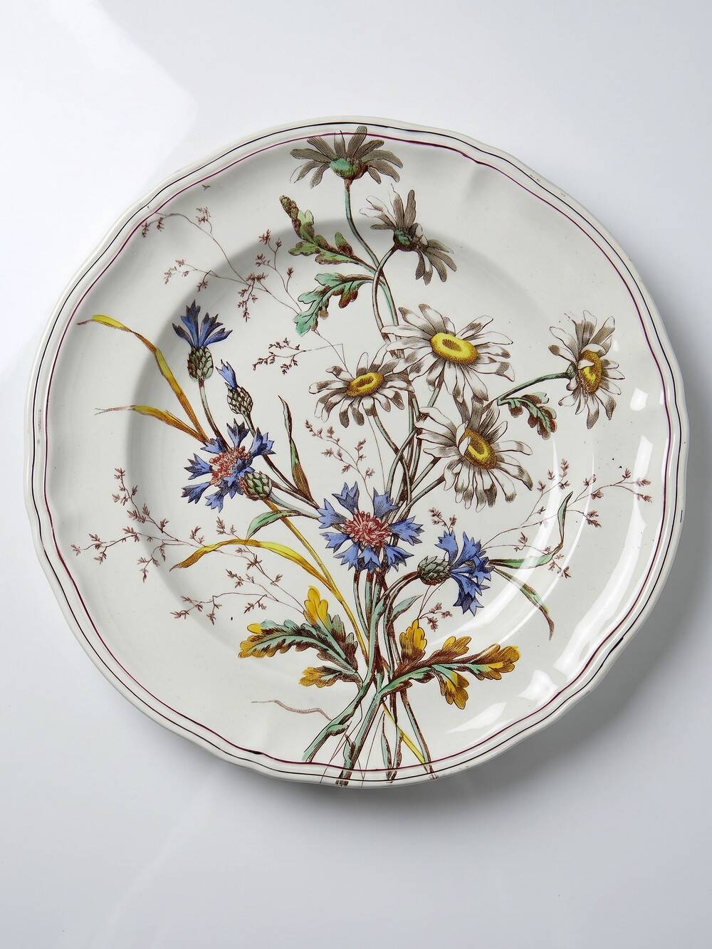Antique Longchamp shallow dish with polychrome daisies in ironstone.