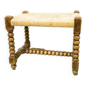 Straw footrest in turned wood