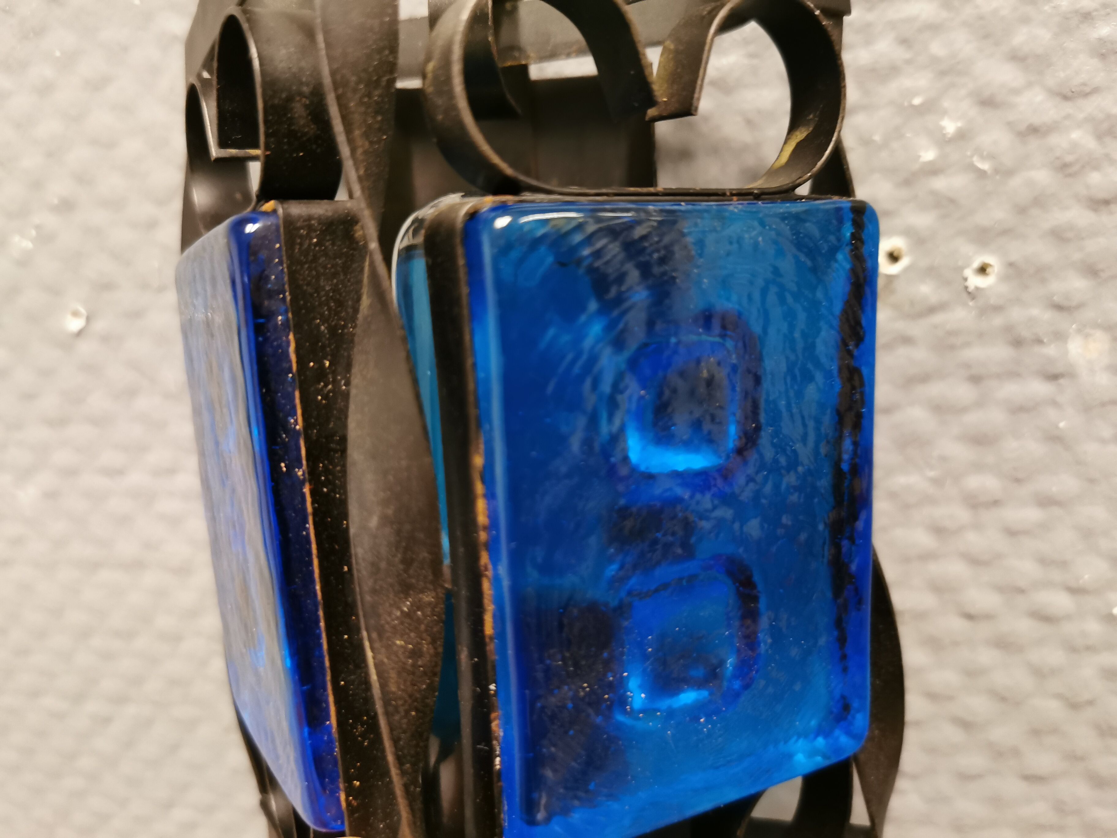 Wall lamps made of black cast iron and handmade thick pressed blue glass
